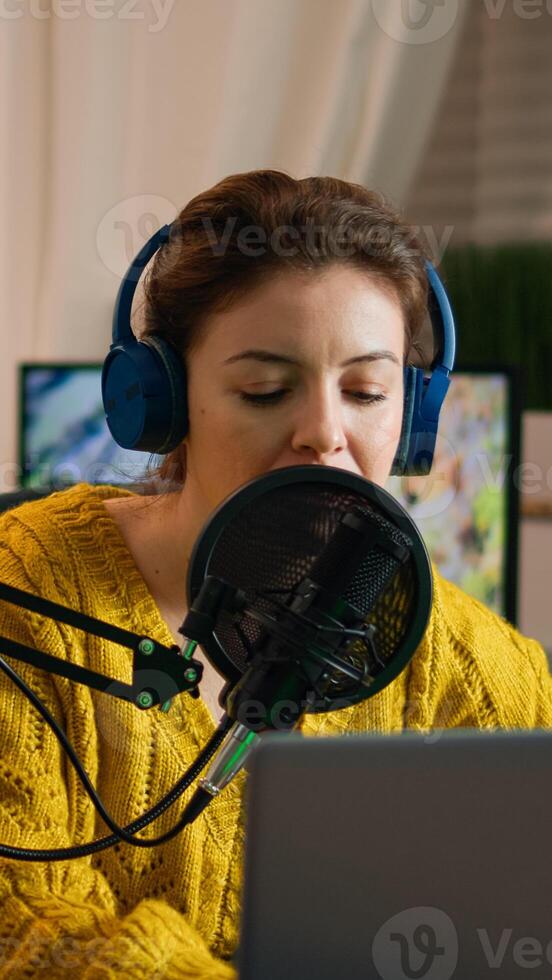 Social media influencer opening laptop starting to record new podcast from home studio. On-air online production internet broadcast show host streaming live content, recording digital vlog photo