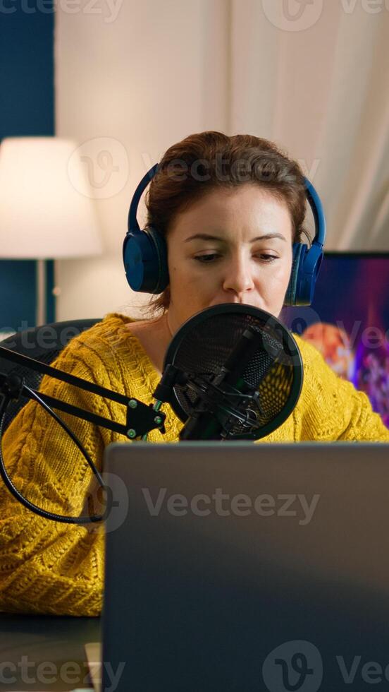 Blogger opening laptop starting to talk with followers recording new podcast at home studio. On-air online production internet broadcast show host streaming live content, recording digital vlog photo