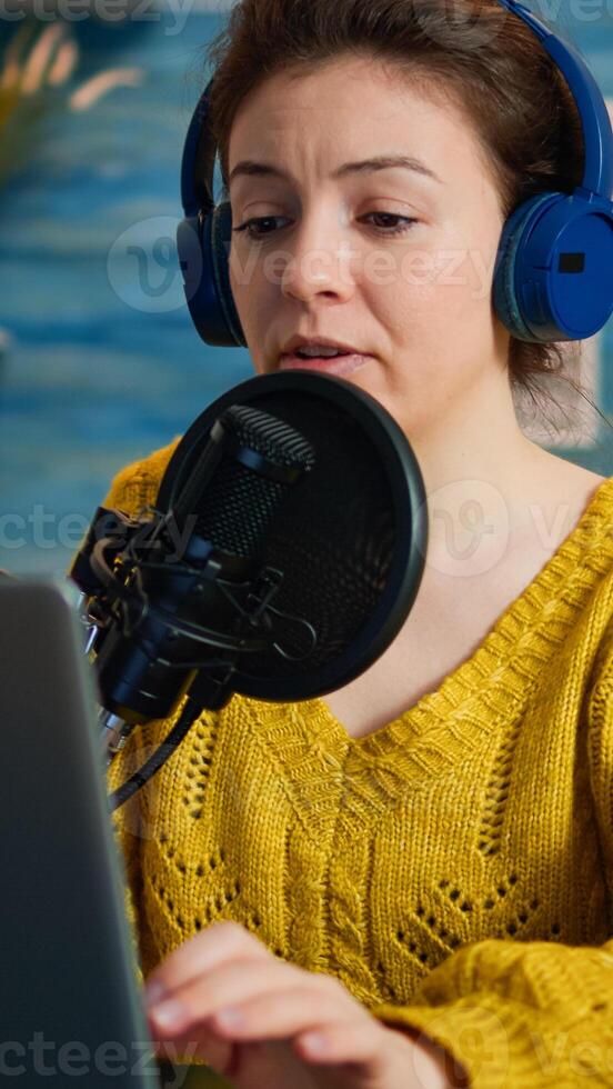 Vlogger looking at laptop while asking audience to subscribe on her channel. Creative online show On-air production internet broadcast host streaming live content, recording digital social media communication photo