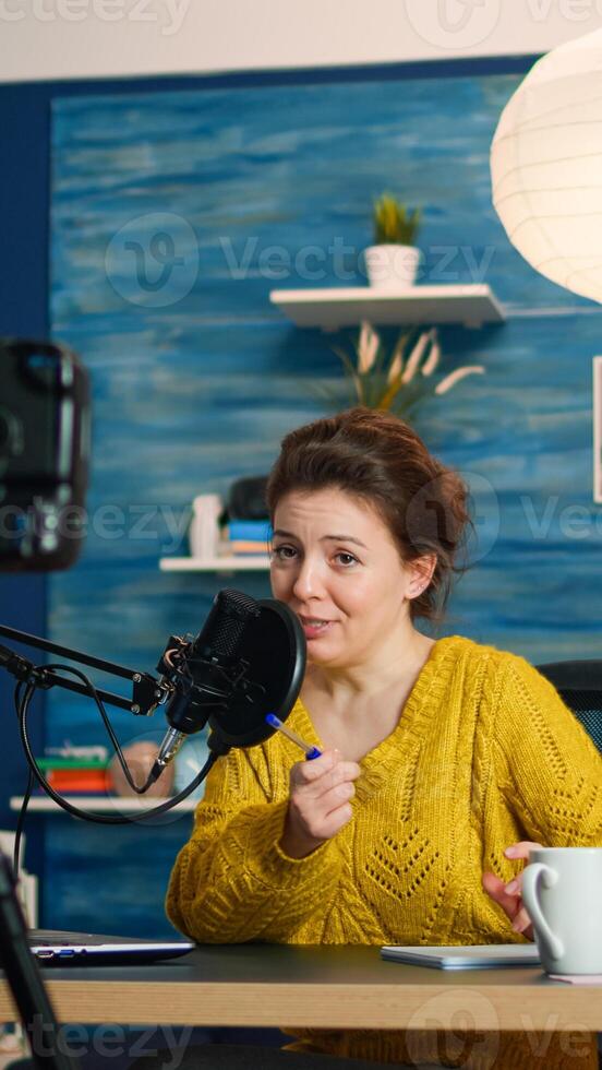 Influencer sitting at home vlog station while camera recording new podcast. Online show On-air production internet broadcast host streaming live content, recording digital social media communication photo