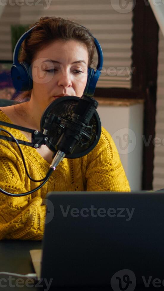 Vlogger on air during online show using laptop, reading emails. Creative online show On-air production internet broadcast host streaming live content, recording digital social media communication photo