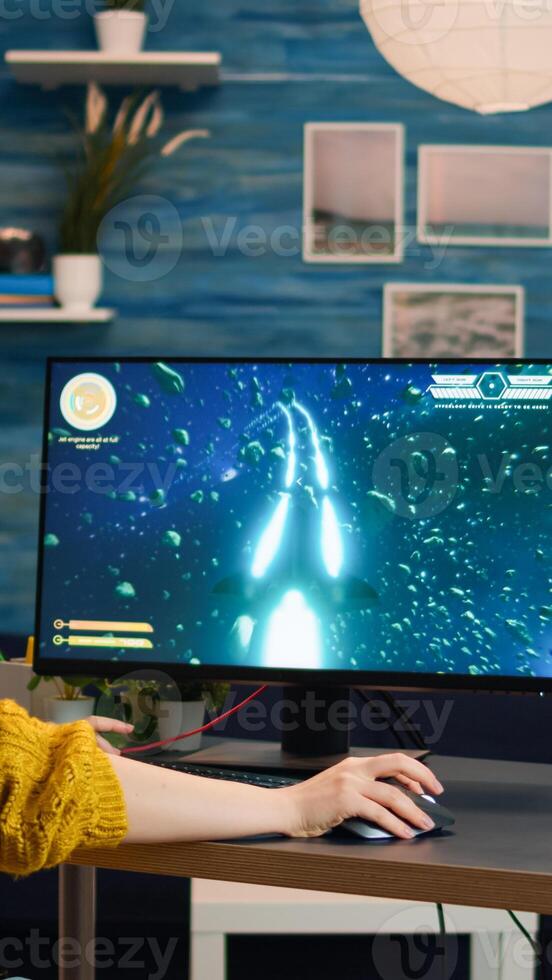 Professional gamer playing first-person shooter online game on powerful personal computer with colorful neon led lights. Cyber performing on pc in stylish room during gaming tournament photo