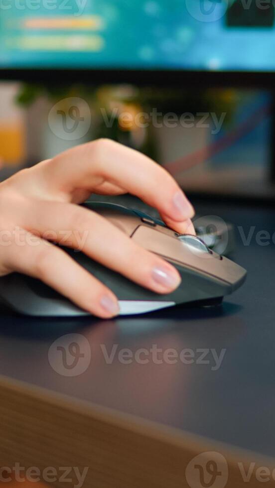Close up hands shot of gamer pushing the keyboard buttons while playing online shooter game. Virtual championship in cyberspace, esports player performing on pc during gaming tournament photo