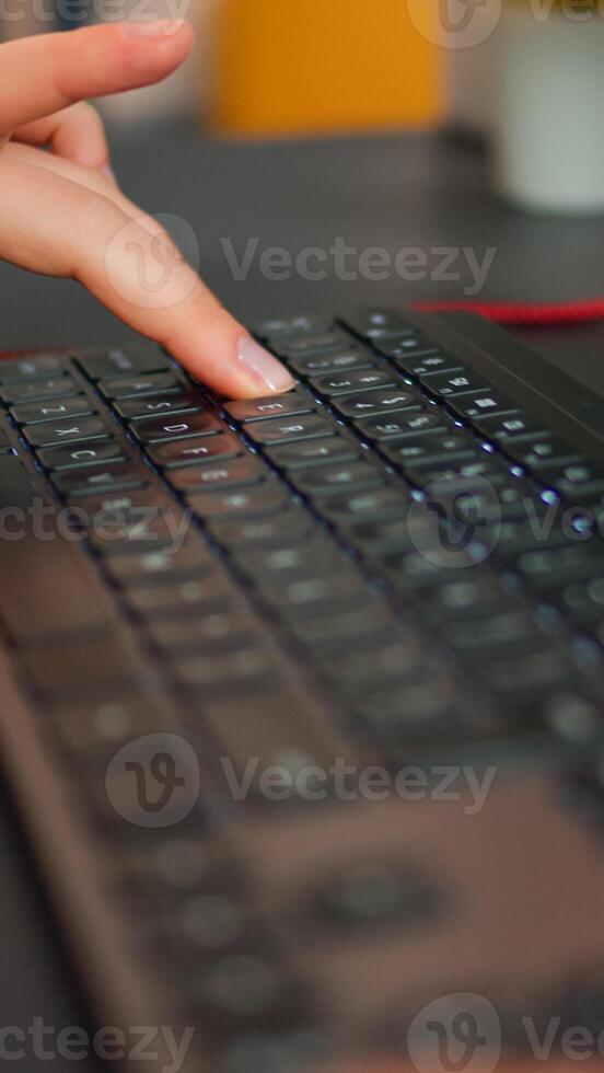 Close-up on hands of woman gamer playing game using RGB keyboard. Virtual championship in cyberspace, esports player performing on pc during gaming tournament using technology network wireless photo