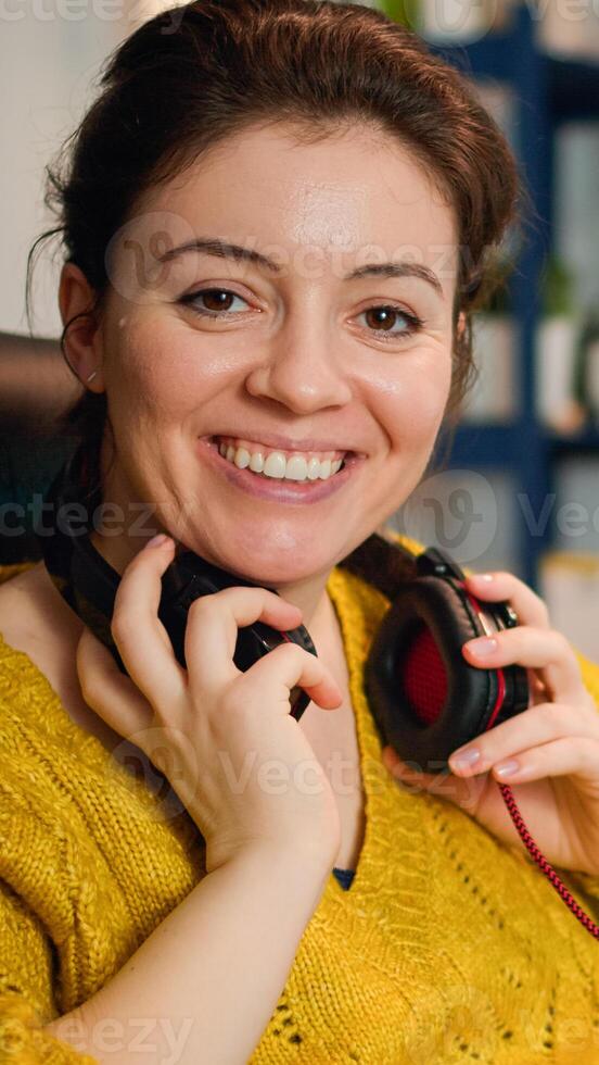 Professional esport woman gamer smiling at camera while compete in game playing on a championship event. Online streaming cyber performing on powerful personal computer during gaming tournament photo