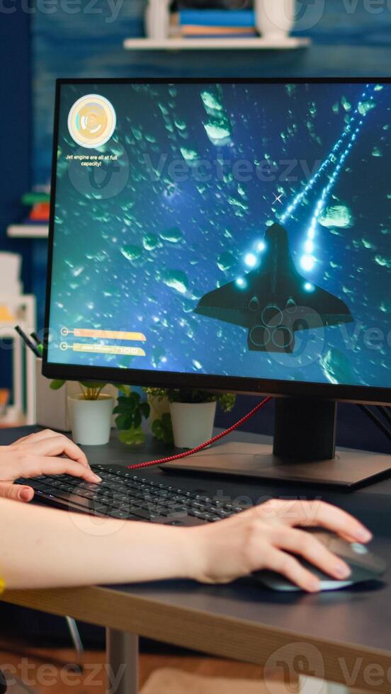 Concentrated gamer playing first-person space shooter online game on powerful personal computer spending loisure time at home. Esport cyber performing during gaming tournament photo