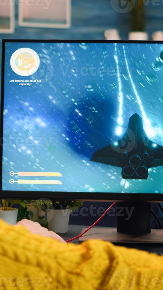 Gamer trying to relax playing space shooter online videogame on powerful pc spending loisure time at home. Virtual shooter game in cyberspace, esports player performing on pc gaming tournament photo