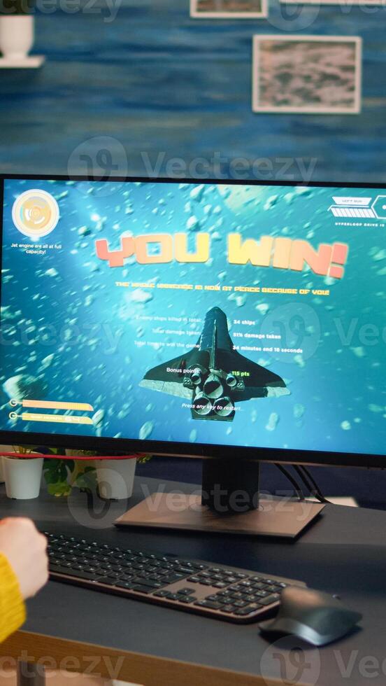 Professional esports gamer playing on computer game, happily and cheerfully celebrates victory and success. Online cyber gaming tournament live streaming event using technology network wireless photo