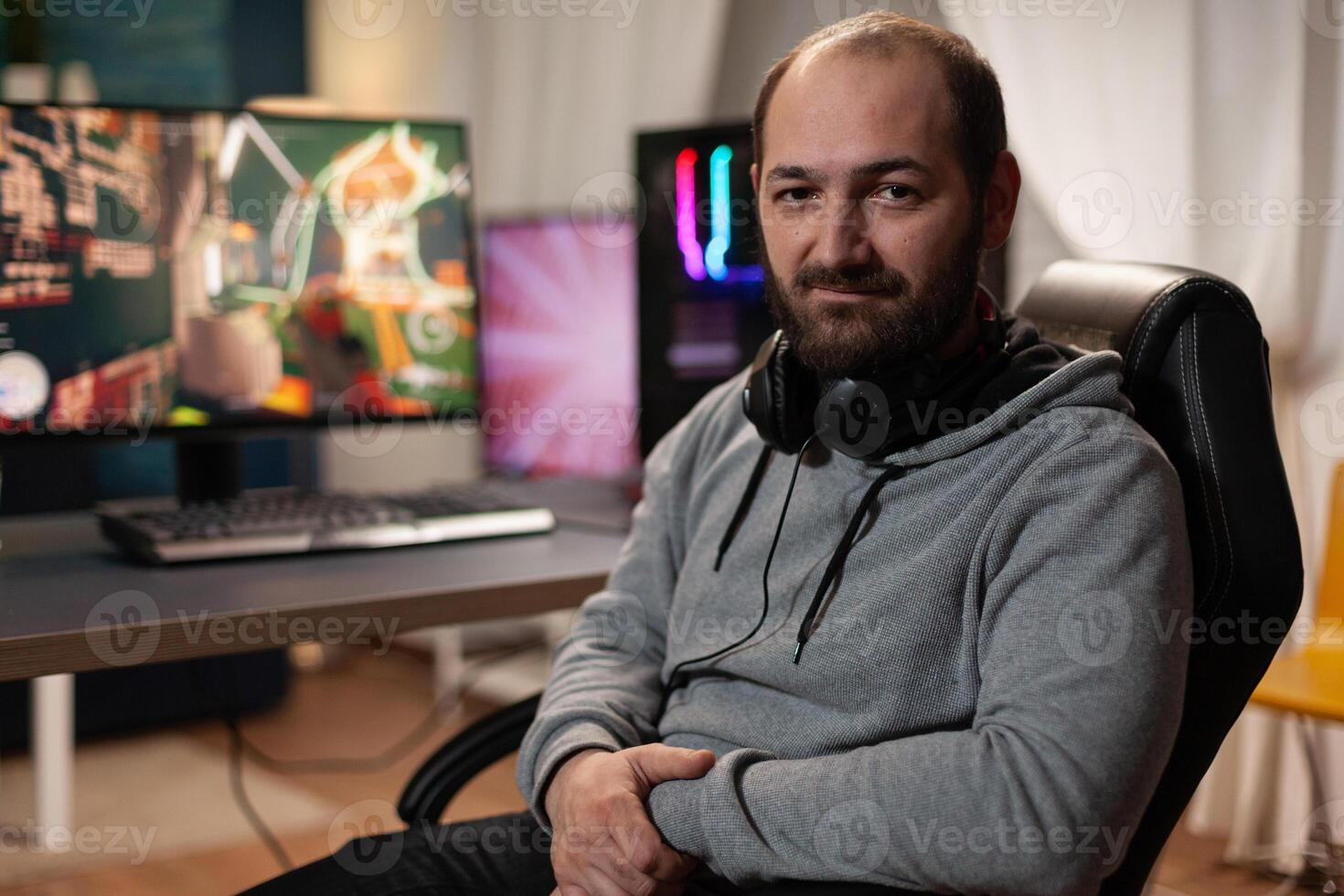 Portrait of man playing games on live stream, using computer and modern gaming equipment. Gamer live streaming gameplay, broadcasting game stream online. Person playing games photo