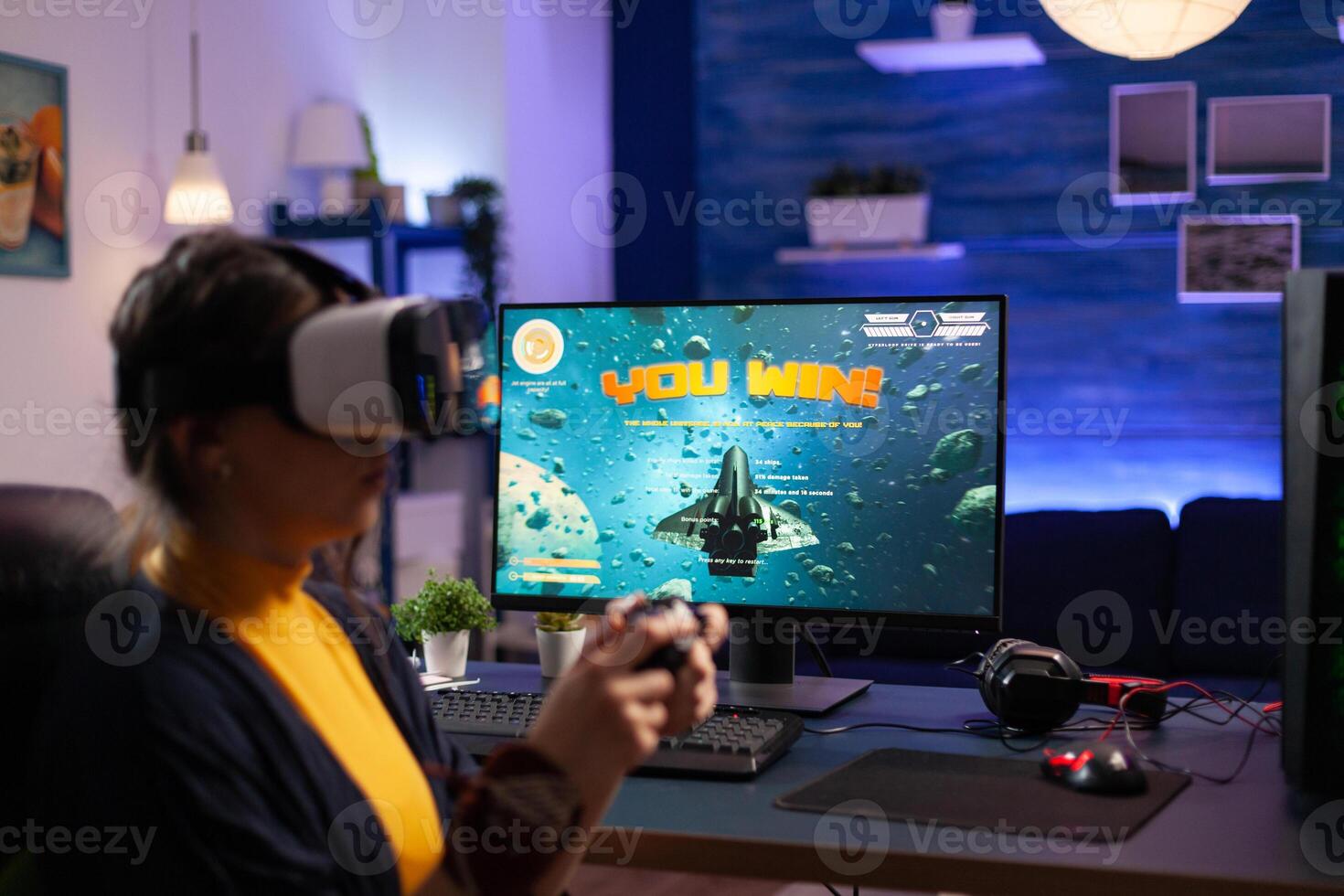 Person playing games with vr glasses on computer. Gamer using virtual reality headset and controller to play and win online game on monitor. Player with modern equipment at desk. photo