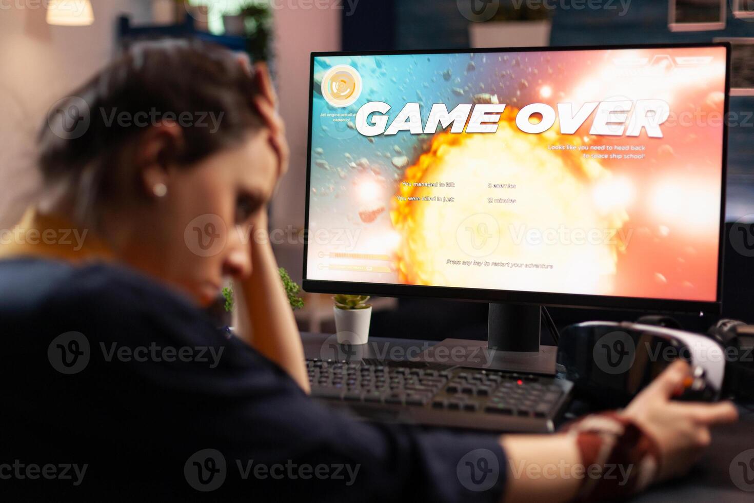 Frustrated woman losing online games on computer. Disappointed person playing on monitor, using controller and feeling sad about lost game. Gamer with electronic e sport. photo