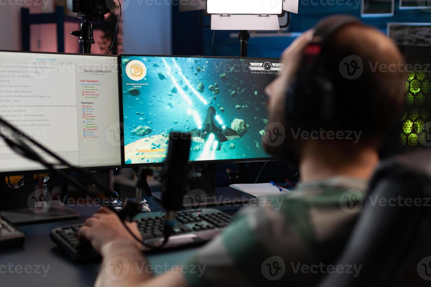 Man playing games on online stream with chat. Gamer using microphone and headset on computer, live streaming gameplay. Streamer broadcasting with gaming equipment in front of on monitor. photo