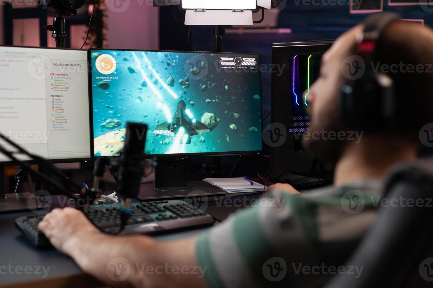 Gamer playing games on stream with live chat. Man using microphone and headset on computer, live streaming gameplay online. Streamer broadcasting with gaming equipment at monitor. photo