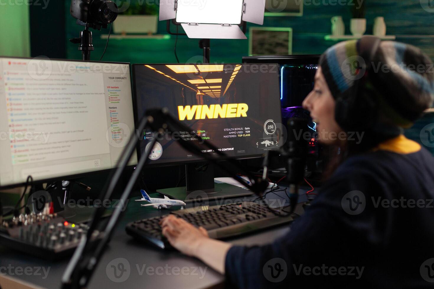 Person live streaming games on monitor. Woman broadcasting gameplay, playing online on stream with live chat, using monitor and microphone. Streamer wearing headphones to play. photo