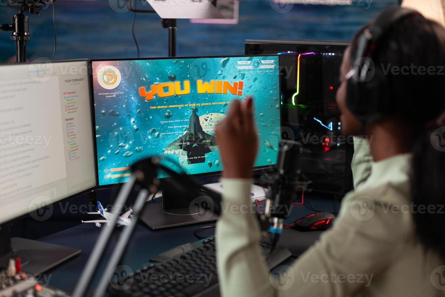 Excited pro gamer woman winner sitting at gaming desk playing esport videogames winning online championship. Successful cyber player streaming live using RGB computer equipment. entertainment lesiure photo
