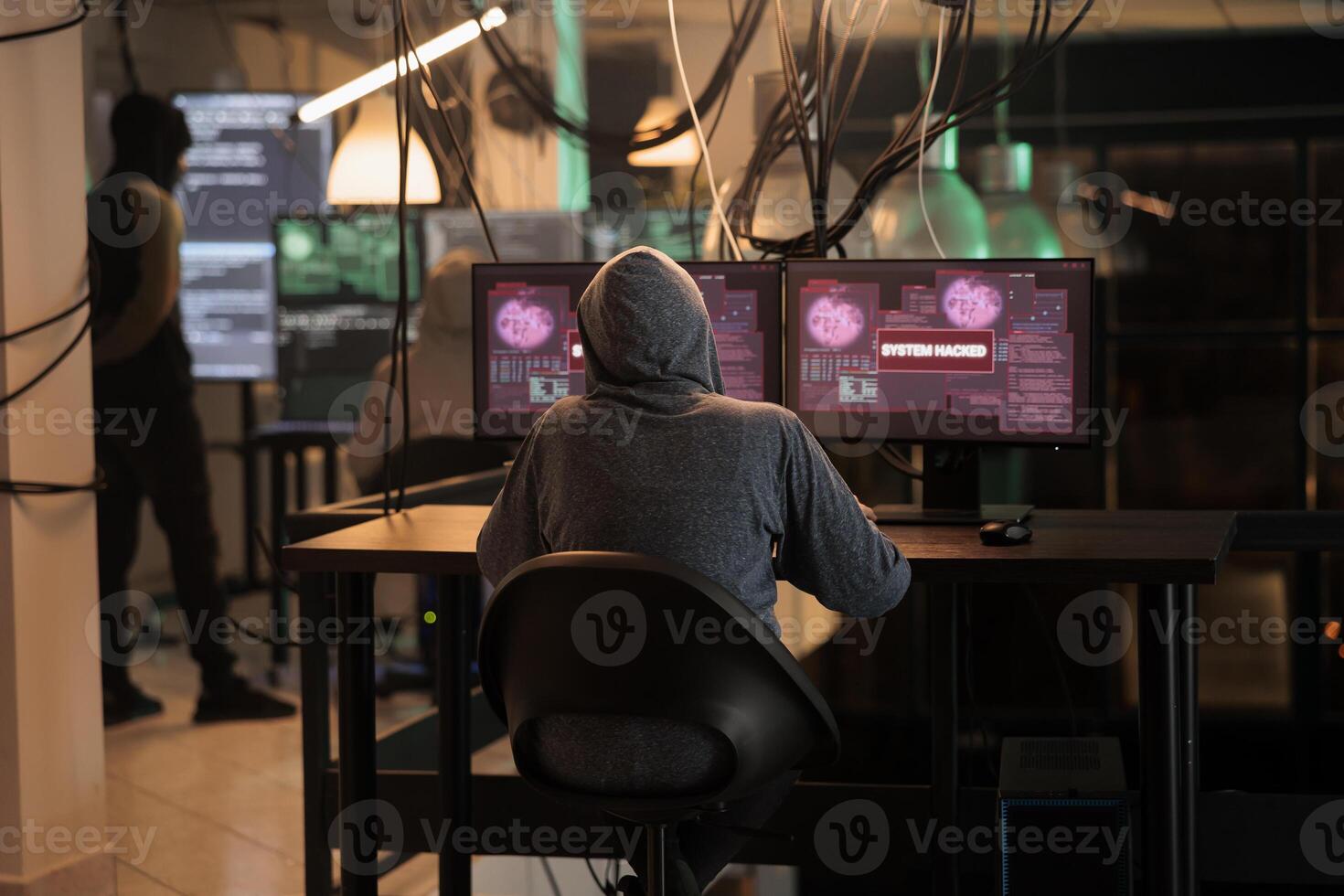 Cybercrime, internet thief hacking computer system, stealing data. Hacker sending virus, breaking into database server, coding spyware, programming malicious software, back view photo