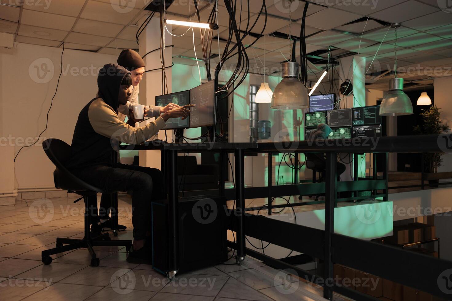 Team of cybercriminals fixing computer system cyberattack, using trojan virus to hack server. Diverse thieves programming app, cybersecurity technology, database spyware protection. photo