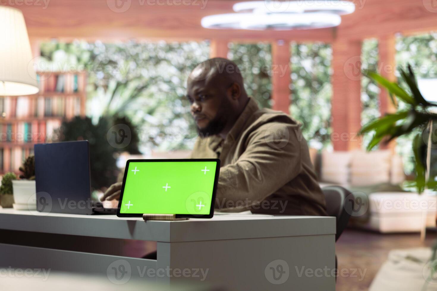 Self employed person working from home next to isolated copy space on laptop, studying market trends and statistics for his online business. Successful freelancer telecommuting with mockup. photo