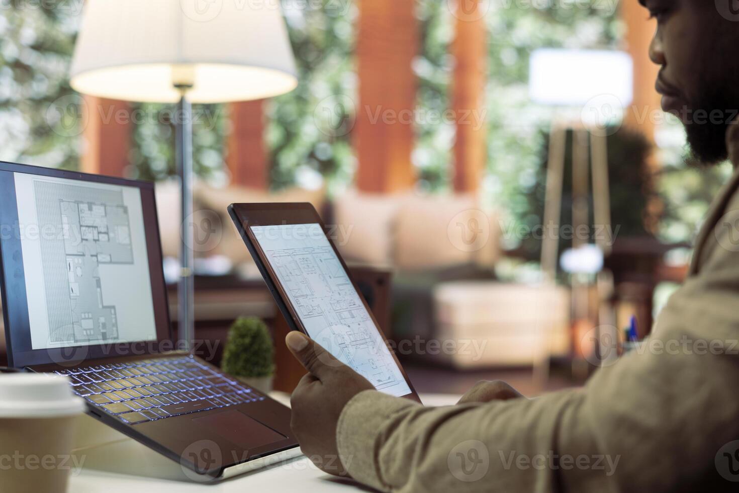 Businessman analyzing architecture blueprints for new office space layout, looking to relocate the startup. Entrepreneur conducts an office hunt, business development and strategy planning. photo