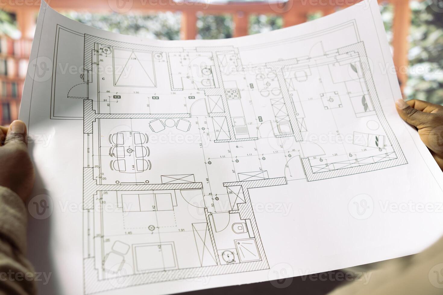 Professional businessman reviewing architectural blueprints for new office hunt, searching for creative workspace. Planning a headquarters relocation with modern layout and interior design. photo
