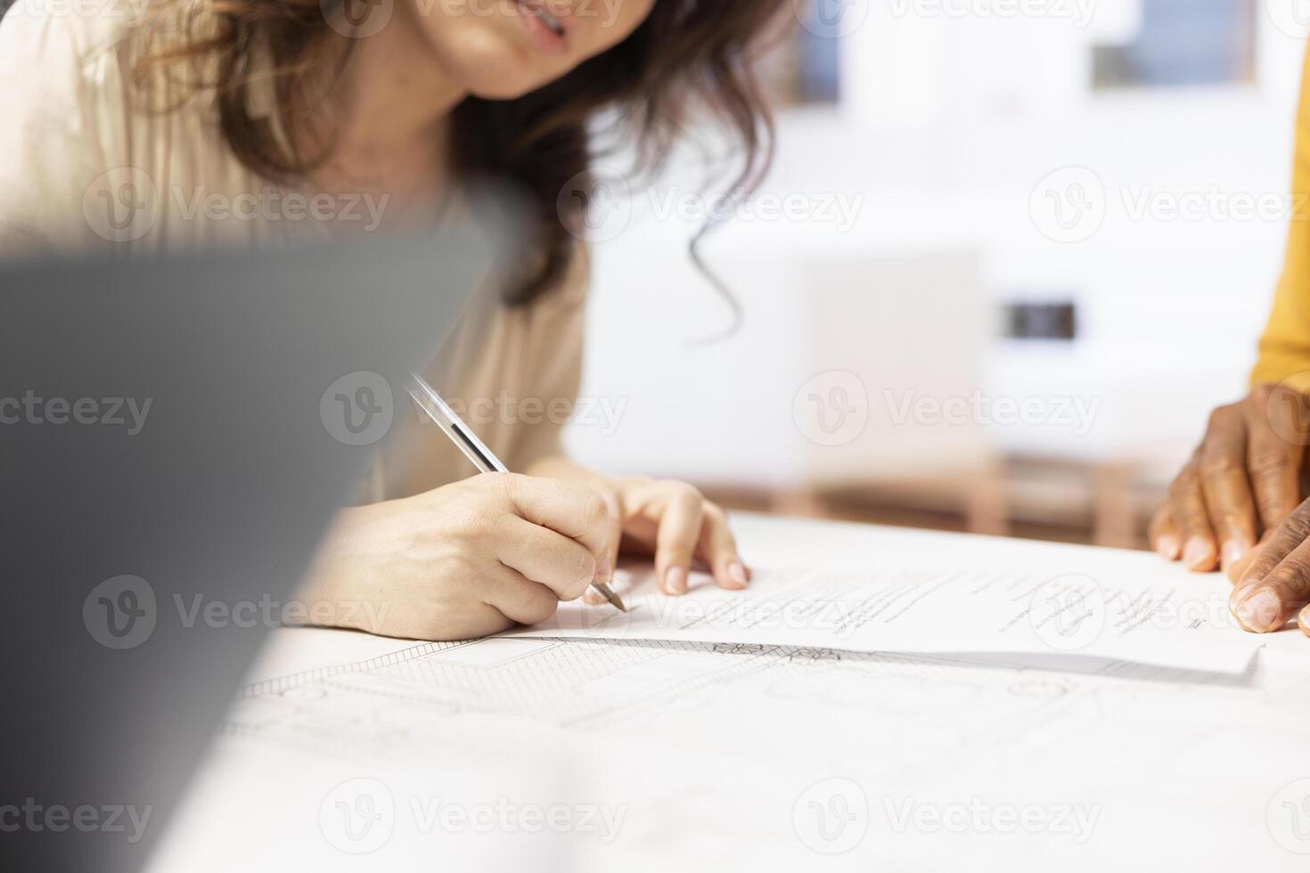 Business woman reaching an agreement with realtor and signing contract for leasing high class modern property for startup relocation and development. Real estate investment planning. photo