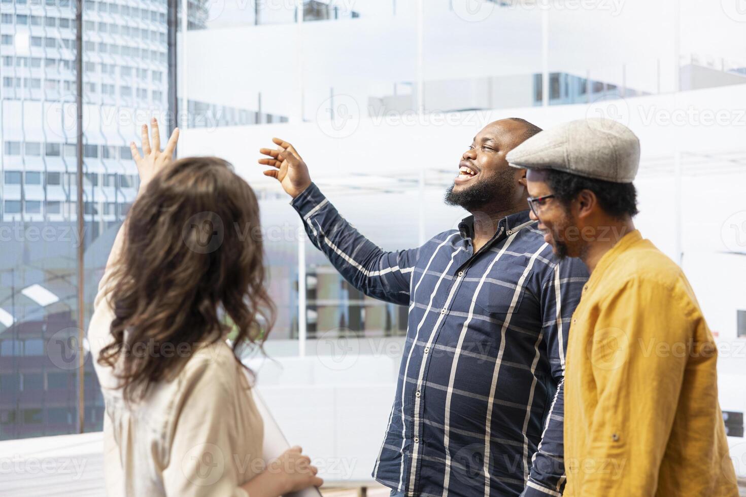 Clients and realtor touring a new high class office space and reviewing layout blueprints for relocation, negotiating leasing contract. Business people investing in urban property. photo