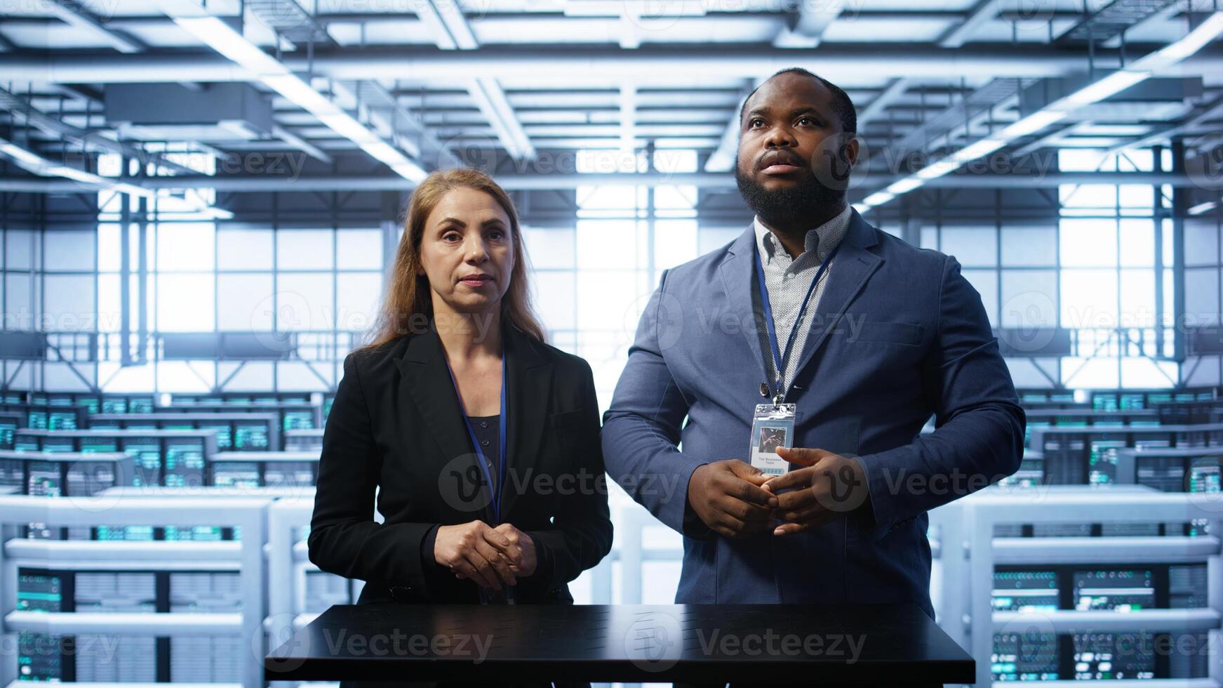 System administrators looking at holograms in data center, doing swiping motions hand gestures. Server farm workplace employees interacting with augmented reality tech, camera B photo