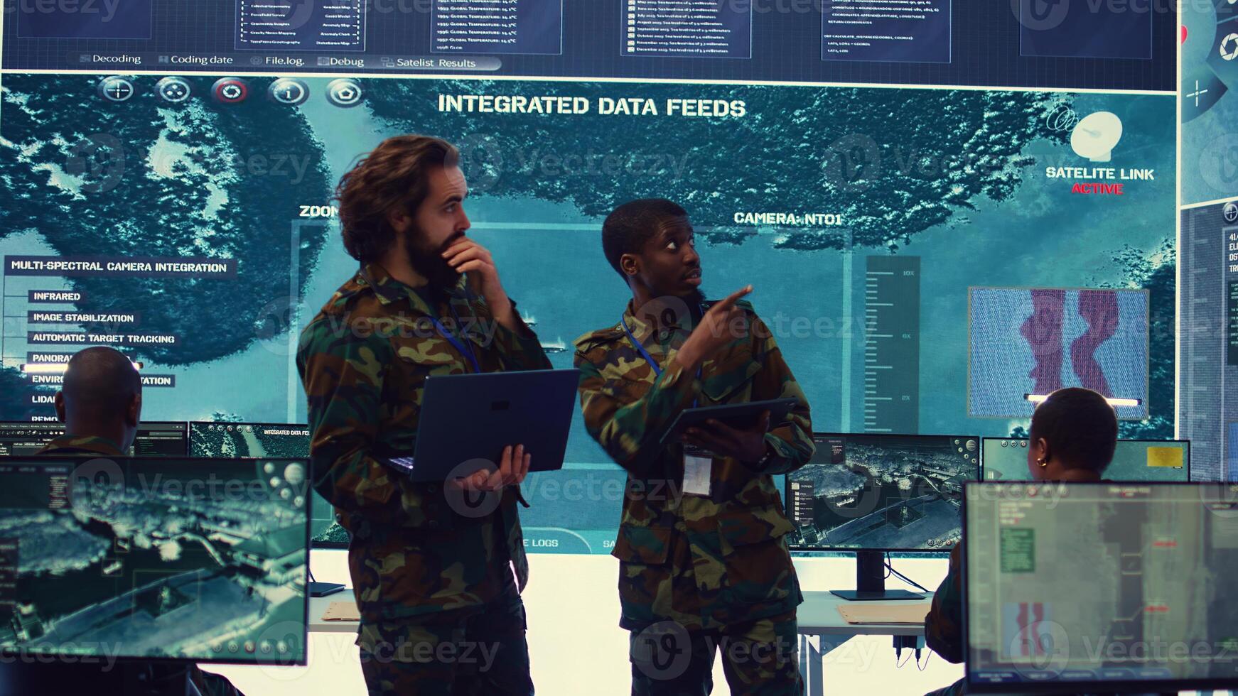 Diverse team of infantry unit leader and commander gather intelligence via radar surveillance, examine a world map to ensure national safety. Officers operating in mission control center. Camera B. photo