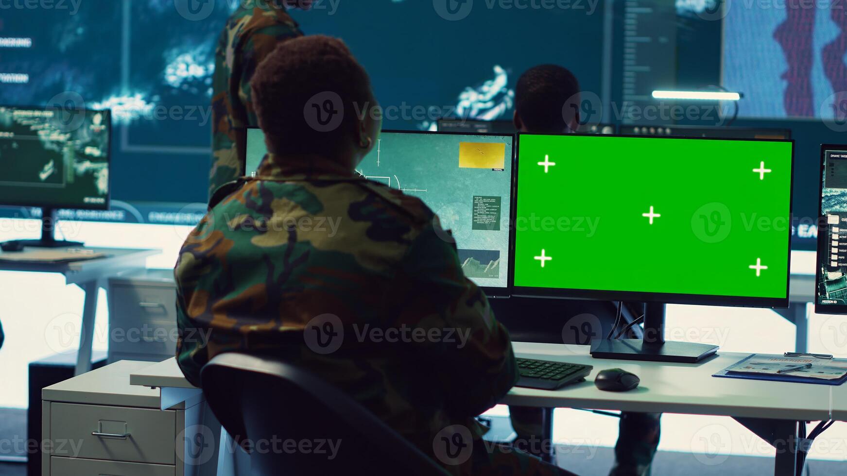 Woman operator works with isolated display and tracking enemy vessels, transmitting gps coordinates to the national guard headquarters. Female soldier operates on CCTV system. Camera A. photo