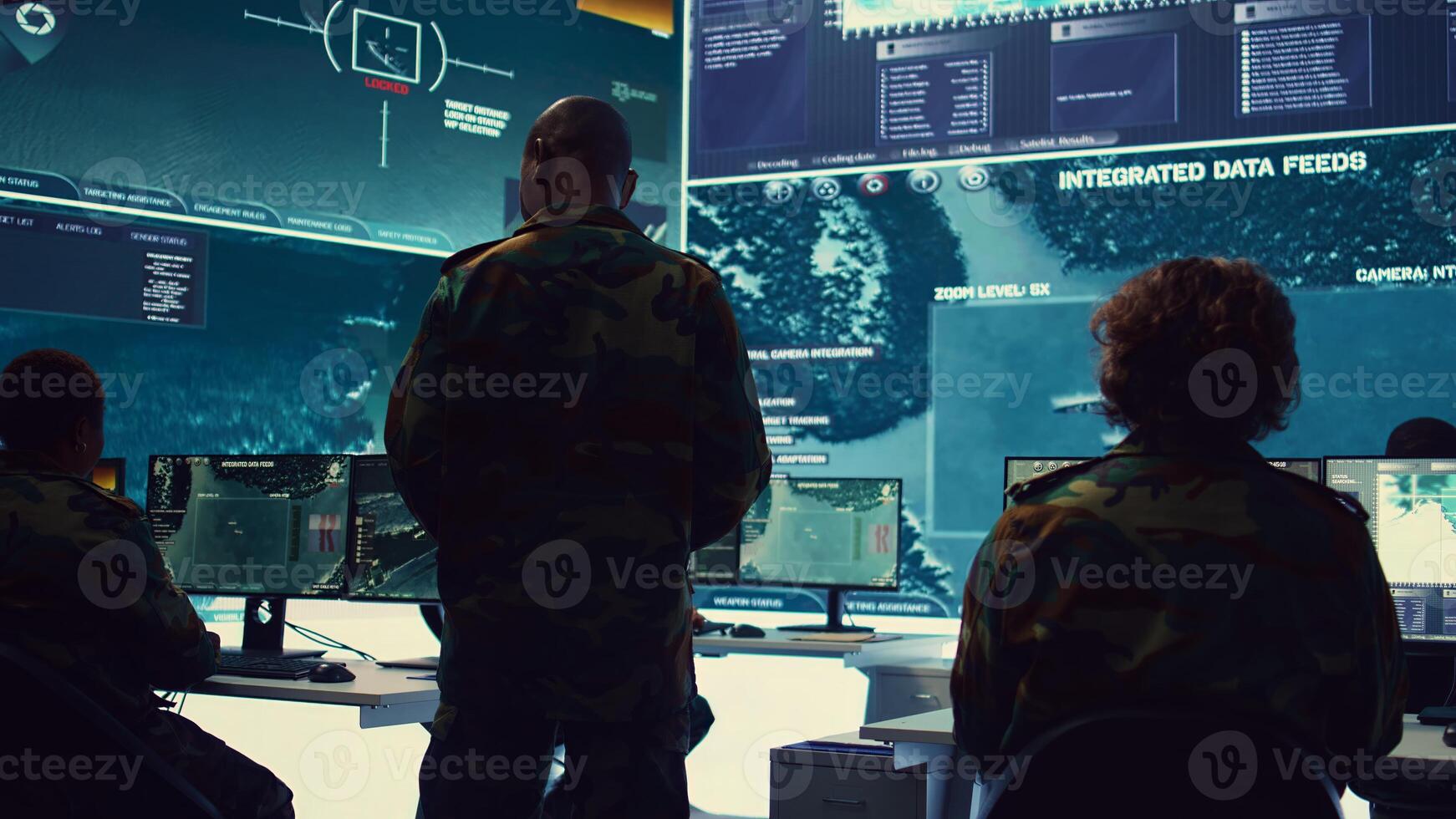 Commander and his crew operating radar systems via CCTV and satellite to detect and track enemy aircraft or missiles. Military officer uses big screen in control center to guarantee safety. Camera B. photo