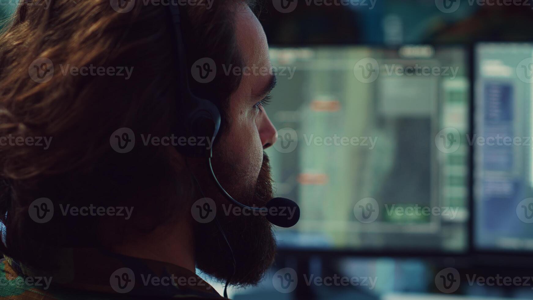 Commander communicating with allied forces and transmitting data from surveillance footage, coordinating joint operations and strategies to accomplish mission. Satellite radar operator. Camera A. photo