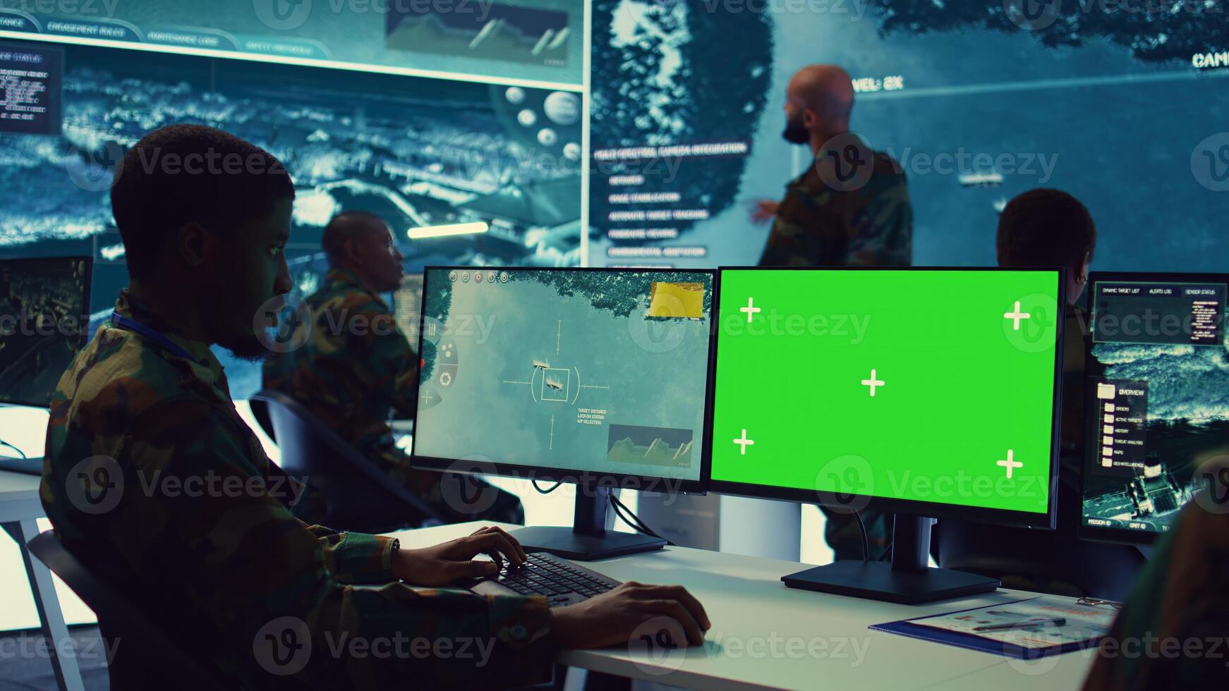 Intelligence analyst reviews ships activity next to an isolated mockup screen, following gps coordinates of vessels anchoring along the coastal ports. Army officer in monitoring room. Camera B. photo