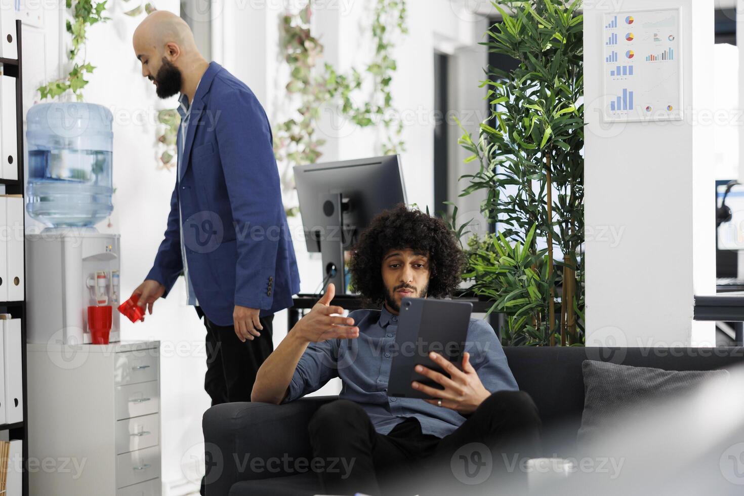 Start up company employee explaining project strategy to coworkers in conference on digital tablet. Unicorn business entrepreneur discussing financial presentation in videocall photo