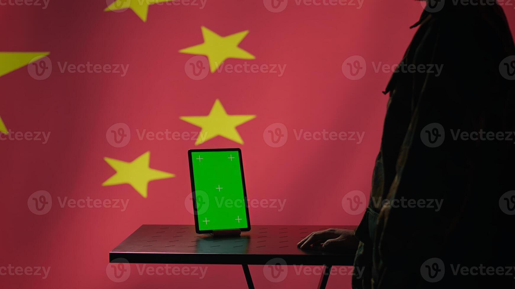 Chinese engineer uses green screen tablet to make fake accounts on social media promoting communist ideology. Technician doing cybersecurity job for CCP government with mockup device, camera B photo
