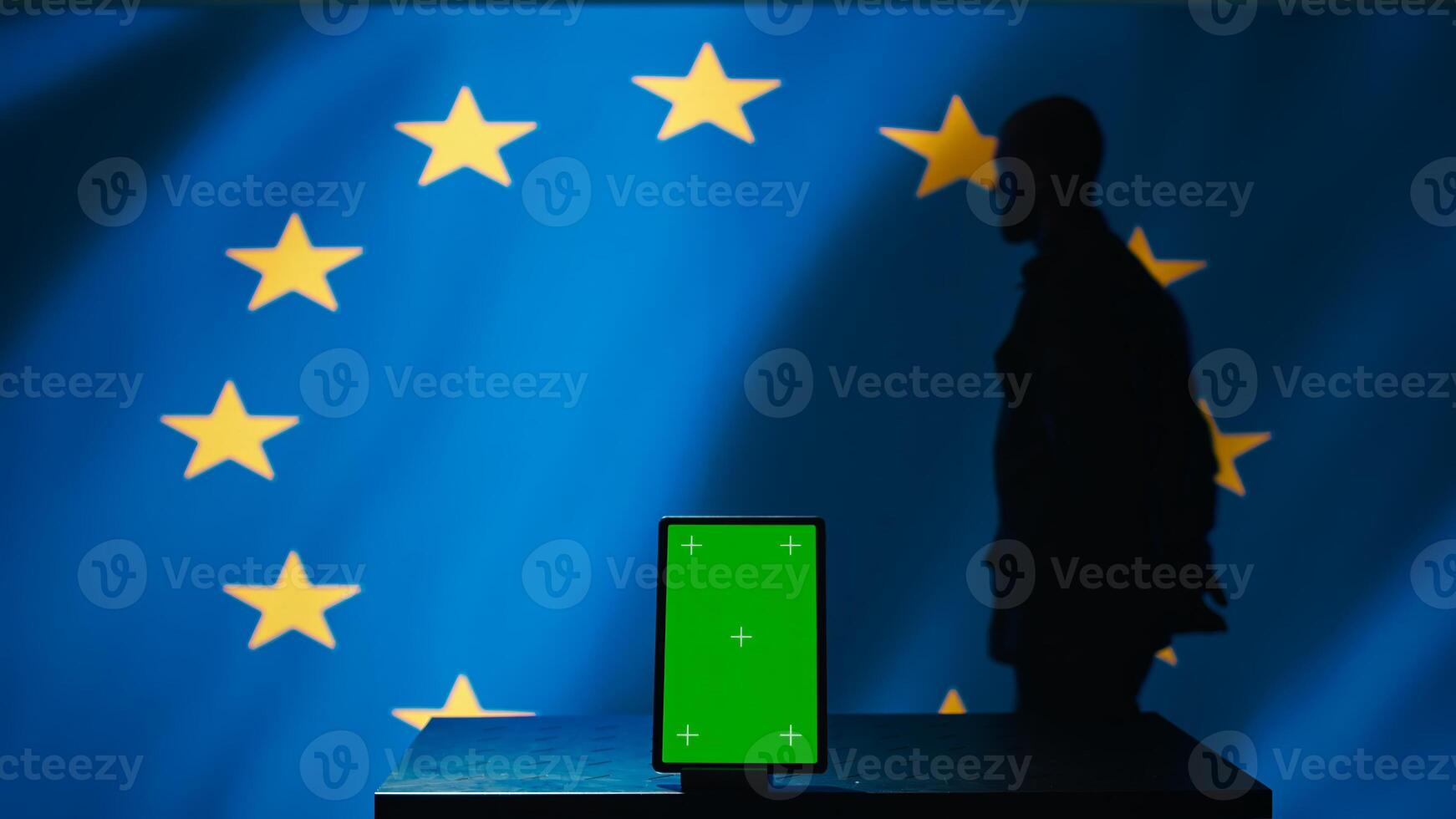 European Union counterintelligence division uses green screen tablet to protect against propaganda affecting elections. EU security service safeguarding democracy online using mockup device, camera B photo