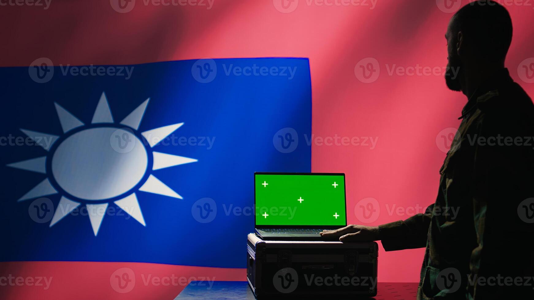 Taiwan liberation insurgent using radar on green screen laptop to detect missiles launched by China. Taiwanese army soldier scanning rockets with mockup notebook during military invasion, camera B photo