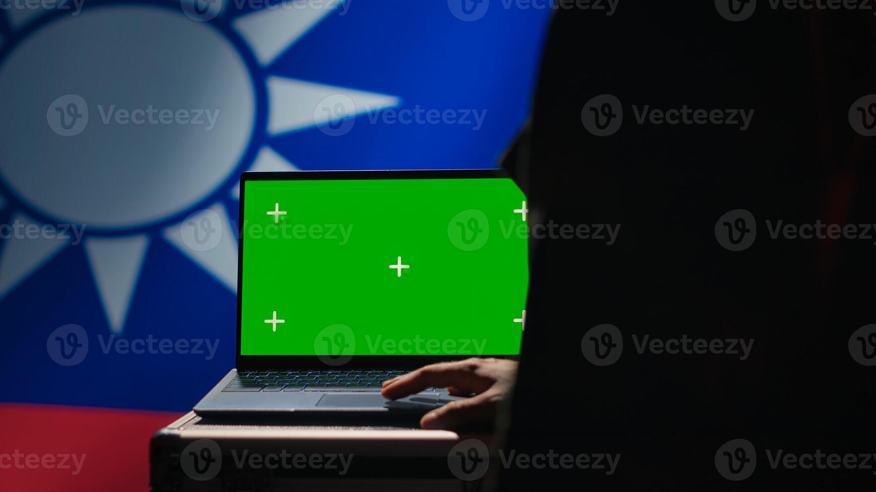 Taiwanese insurgent using military tech on green screen laptop to identify threats from enemies. Taiwan freedom fighter using software on mockup notebook to relay info to war front lines, camera A photo