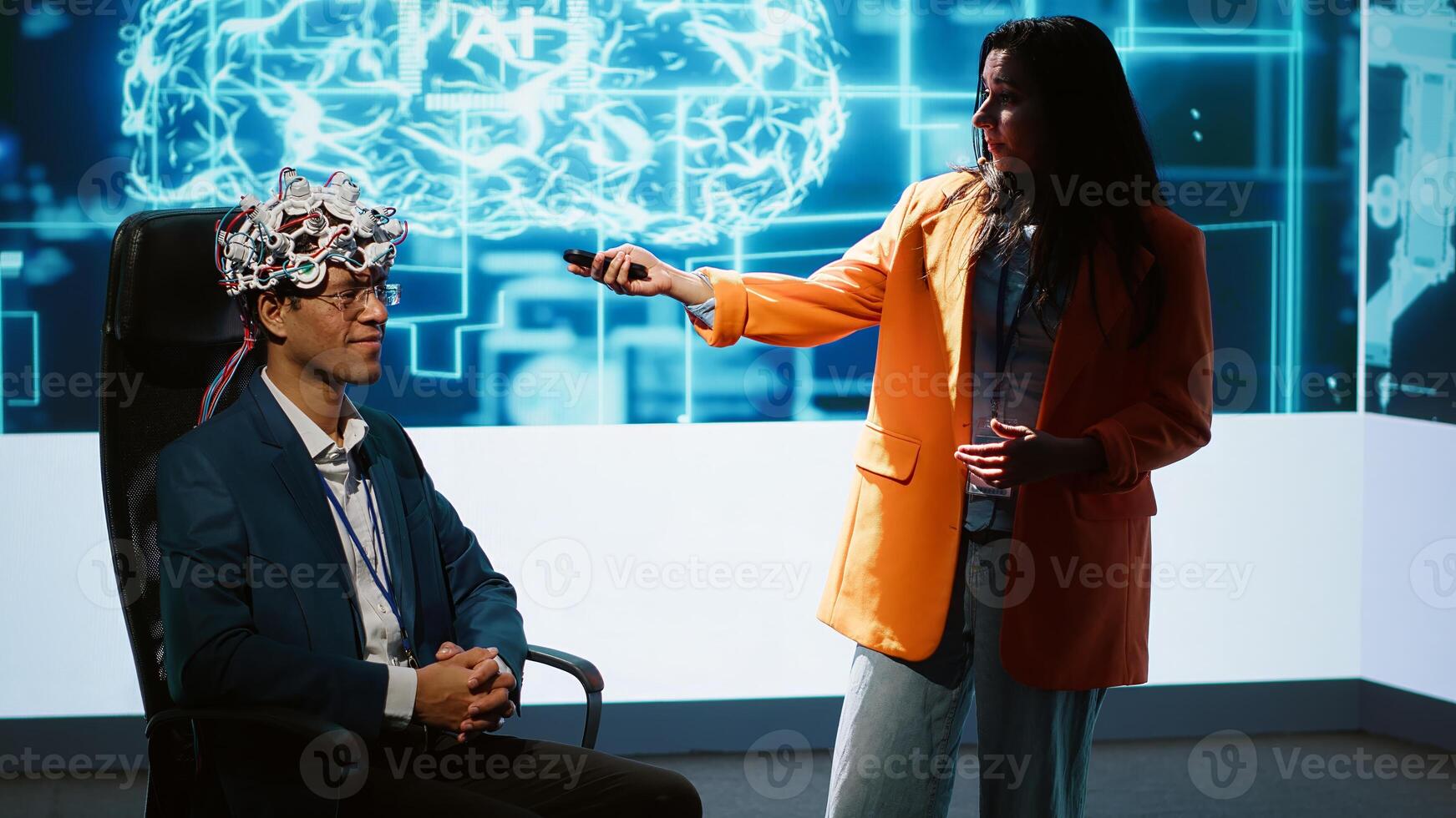 Neuroscientist doing demonstration at AI convention gathering tech startups and academics, showing how to use EEG headset to link brain with artificial intelligence, camera A photo