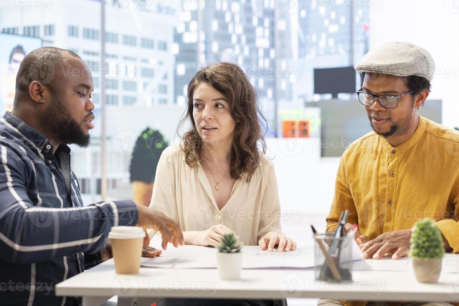 Professional brokers and client discussing rental investment strategy during an office tour, evaluating architectural blueprints for a high class corporate office space. Workspace relocation. photo