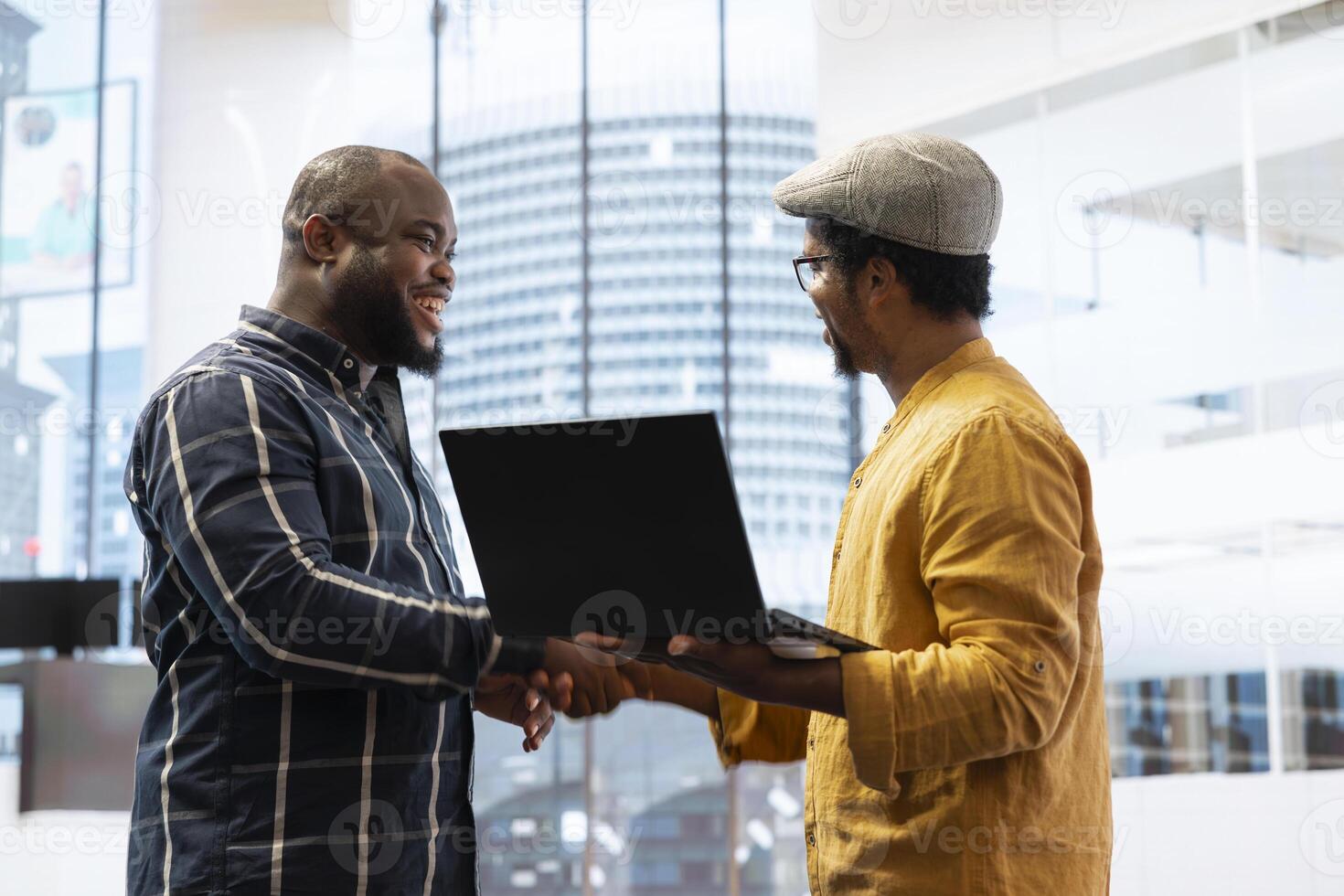 Business owner planning a property investment during office tour with broker, examining the building layout on architectural blueprints and sharing his vision. Office relocation strategy. photo