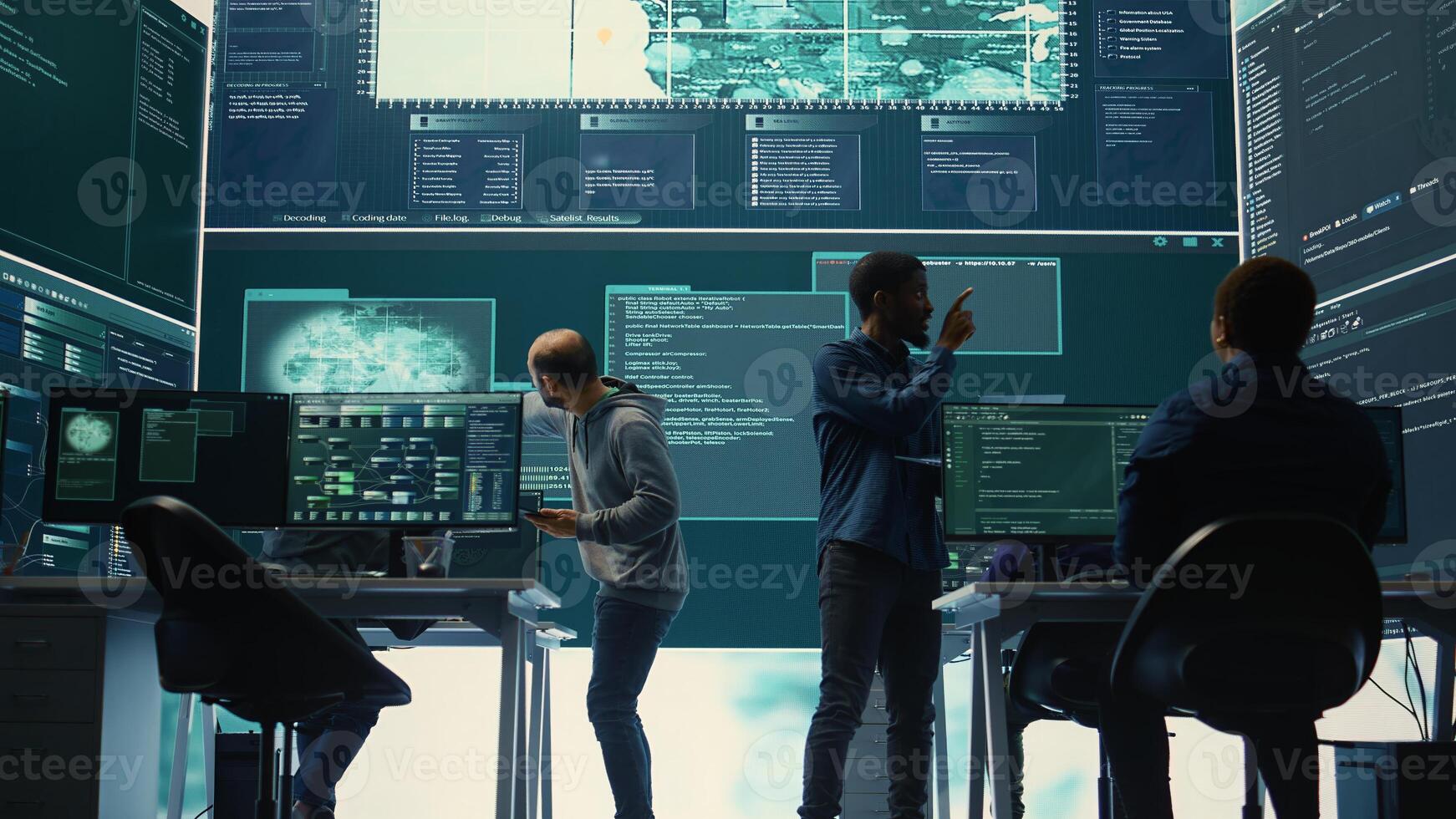 Governmental hackers analyzing cyber threats on big screens, managing important database hacking activity in high tech agency office. Work on cyber defense to protect national security. Camera B. photo