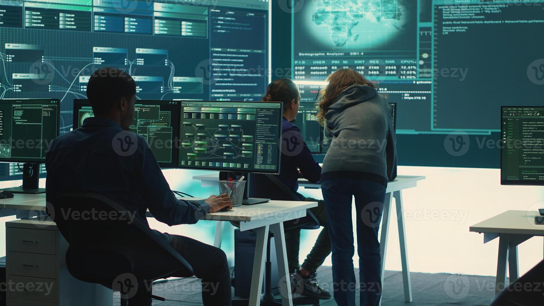 Governmental hackers team securing computer systems from cyber threats, working together in agency control room. Emphasizing encryption, online security and espionage against cyber attacks. Camera A. photo