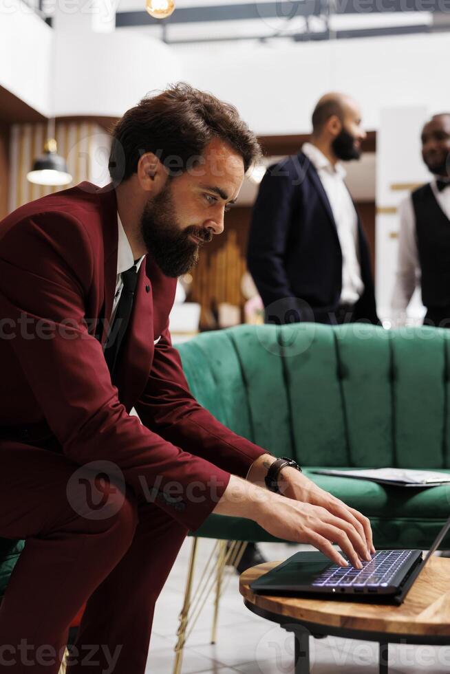 Corproate representative create speech to present at international business meeting, trying to impress executive board members. Professional in suit travelling for work purposes. photo