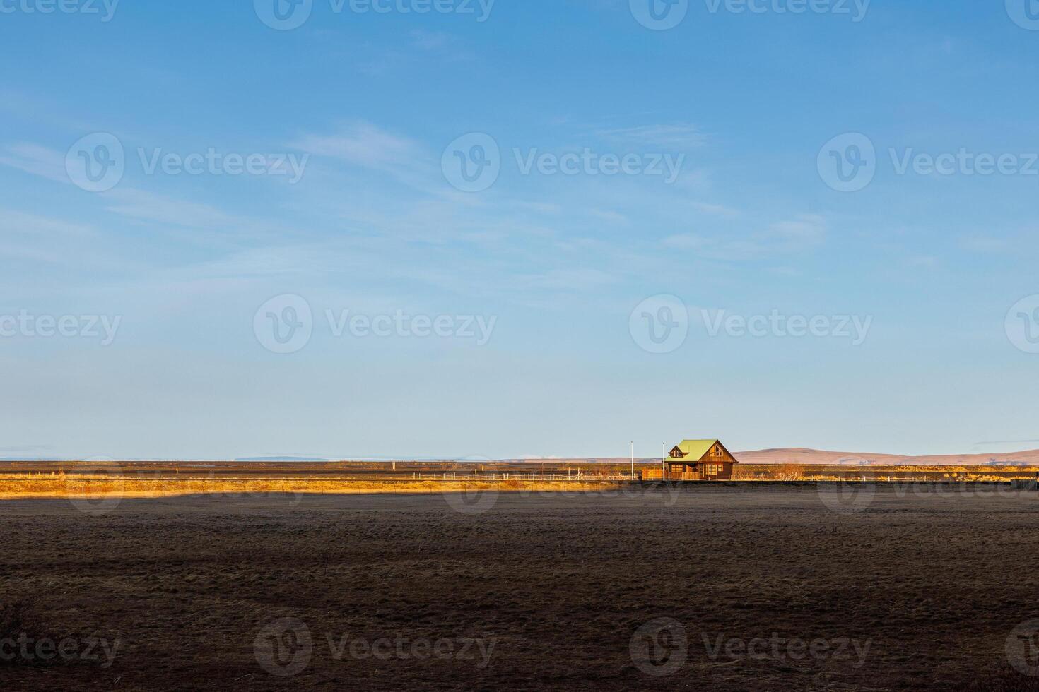 Scandinavian farmland with vast fields and lovely residences next to mountain peaks. Amazingly stunning hills forming scenery with lands, icelandic valleys and idyllic surroundings. photo
