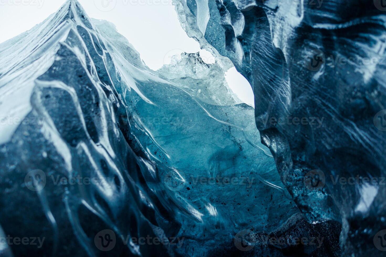 Vatnajokull ice mass at scandinavian location, containing big fragments of ice inside gap used for glacier hiking. Glacial blocks inside caves and passageways, climate change theme. photo