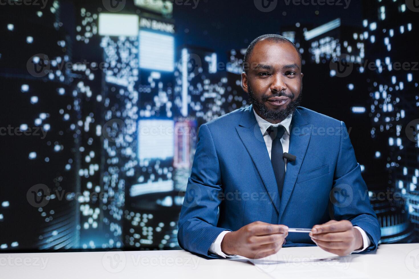 News presenter on live night show transmitting latest information, broadcasting reportage for television content. African american media journalist reading daily headlines in newsroom. photo