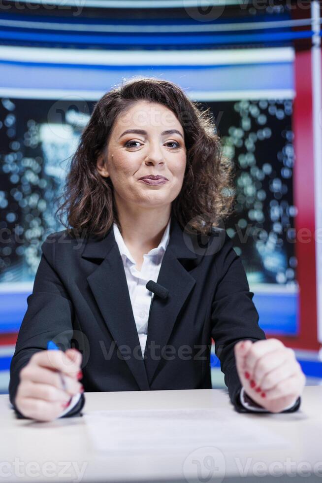 Show presenter hosting media segment to discuss about live daily events, talking about celebrities and global issues. Television host creating news report using headlines, broadcasting on tv. photo