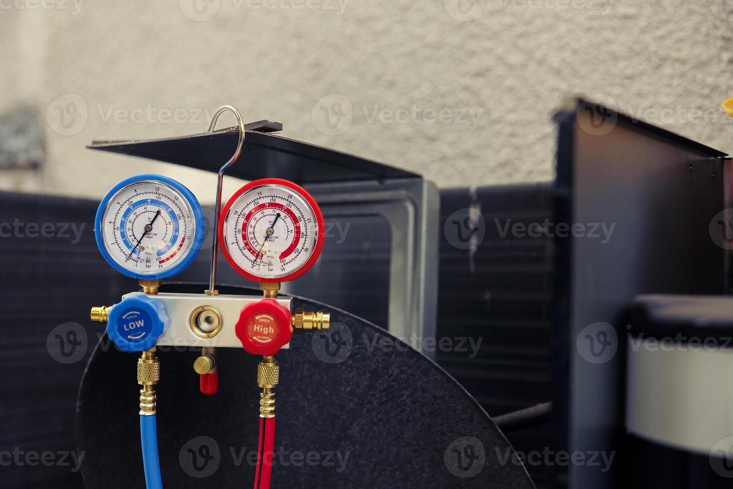Close up of manifold gauges used for checking air conditioner refrigerant in need of maintenance. Set of barometer high or low freon levels benchmarking hvac system component photo