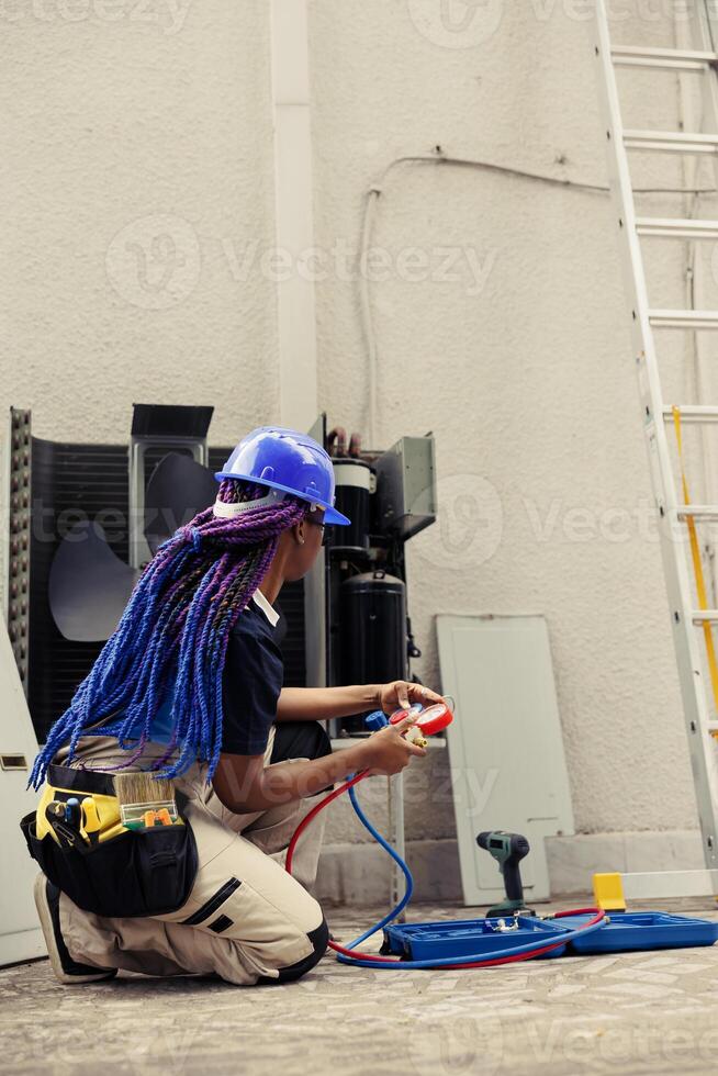 Trainer repairman preparing for routine hvac system maintenance. Competent mechanic unpacking toolkit with professional instruments needed to clean clogged air filters restricting airflow photo