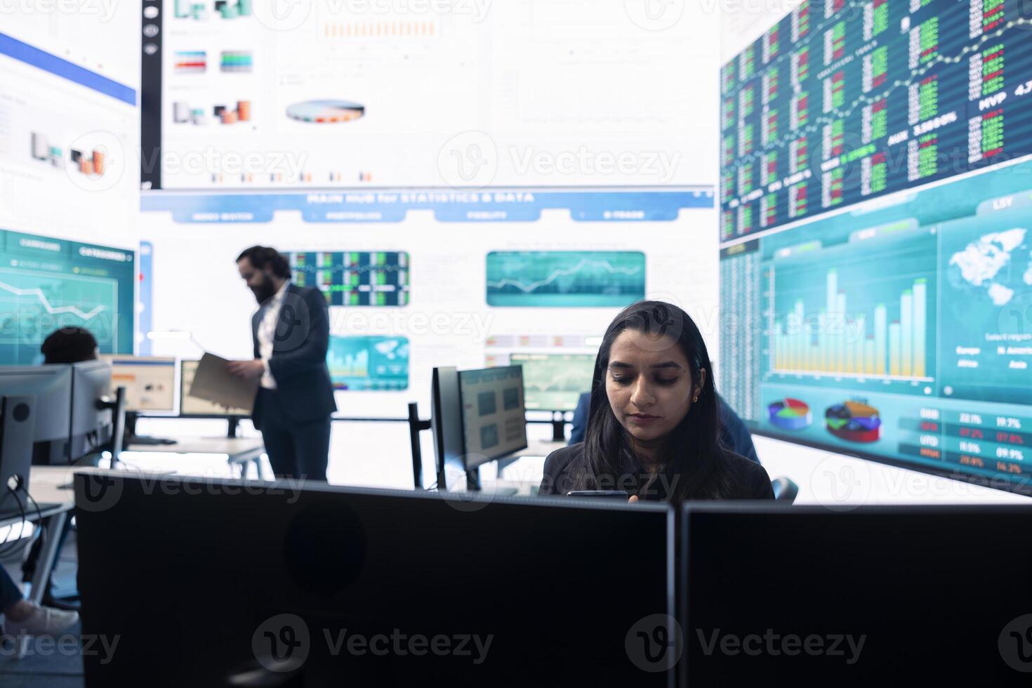 General manager working on data management with infographics and business activity reports, ensuring objective achievement. Shareholder reviewing an investment for global expansion. photo